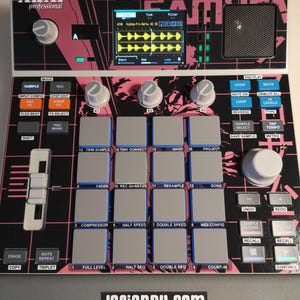 May include: A black and pink AKAI professional MPC sample machine with numerous buttons, knobs, and a screen displaying audio waveforms. The device features a grid of pads, labeled buttons, and a sticker that reads "Lofiandy.com".