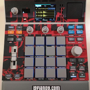 May include: A music production sampler featuring a red and black graphic design with the text IT'S ALL RIGHT. THERE'S NO WAY ILLUSIONS CAN COME TO LIFE. The device has a central screen, sixteen grey square pads, multiple control knobs, a vertical fader, and various function buttons. The bottom edge displays the text lofiandy.com.