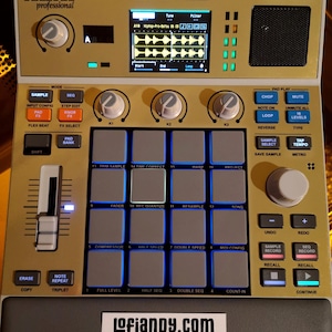 May include: A gold and black Akai MPC Sample professional music production device. It features a screen displaying waveforms, numerous buttons, knobs, and pads for music creation. The device has the website address lofiandy.com.