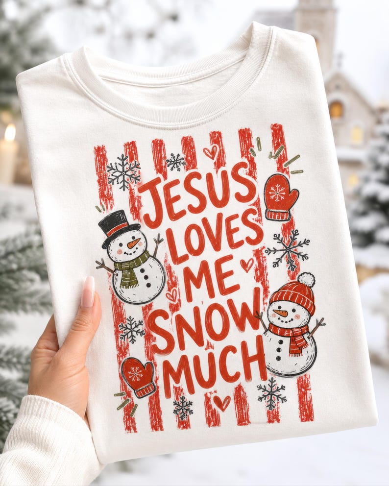 May include: A white crewneck sweatshirt featuring a red and white striped background graphic with the text JESUS LOVES ME SNOW MUCH. The design includes two snowmen, one wearing a black top hat and one in a red beanie, plus red mittens and snowflakes.