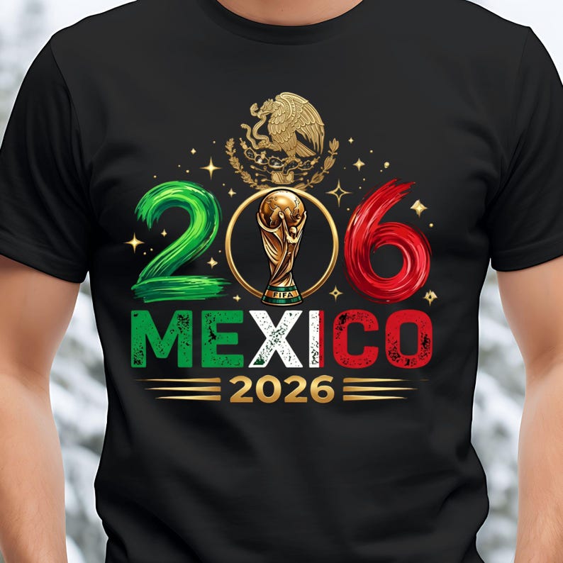 May include: A black t-shirt featuring a graphic with the number 206, where the zero is replaced by a gold FIFA World Cup trophy. Above is the Mexican coat of arms. Below, the word MEXICO is in green, white, and red, followed by 2026 in gold.