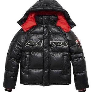 May include: Black puffer jacket with a hood and red lining. The jacket features the text "Avirex" in white and black, along with a small patch on the sleeve. The jacket has a shiny, quilted appearance.