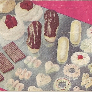 May include: A silver tray filled with a variety of cookies and pastries, including chocolate eclairs, meringue cookies, and shortbread. The tray is on a pink background.