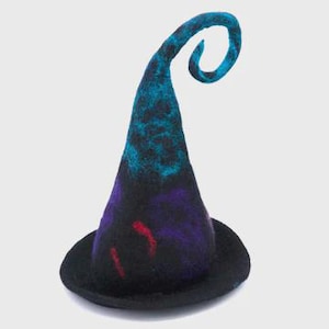 May include: A tall, pointed hat made of felted wool featuring a black base colour with blended accents of vibrant blue, deep purple, and thin red streaks. The top of the cone-shaped crown curves into a distinct spiral tip, and the brim is circular.