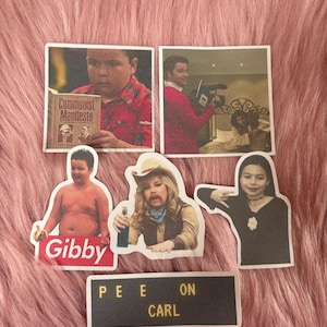 May include: A collection of six stickers featuring various pop culture images and text. One sticker shows a person holding a book titled Communist Manifesto, another shows a person with a camera, and others feature characters with the text Gibby and PEE ON CARL.