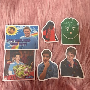 May include: A collection of six stickers featuring characters and scenes from the television show iCarly. The stickers include a rectangular print with the text YOU WILL RUE THIS DAY, a green character, and various portraits of individuals.