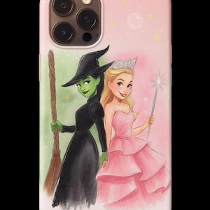 May include: A phone case with a Wizard of Oz illustration. It depicts a green-skinned witch in a black dress and hat, holding a broom, and a blonde woman in a pink dress, holding a wand. The background is pink and green.
