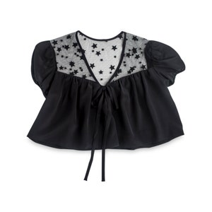 May include: A black cropped top with a sheer star-shaped overlay and a tie at the front.
