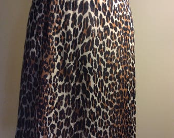 May include: A brown, black, and white leopard print skirt with a scalloped hem.