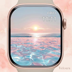 May include: A gold smartwatch with a screen showing a sunset over the ocean. The watch face displays the time 11:11 and the day, Friday. The watch strap is a light beige colour.