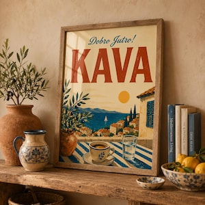 May include: A framed art print with the word "KAVA" in large red letters. The print depicts a coastal scene with a cup of coffee, a glass of water, and the text "Dobro Jutro!" above. A vase of olive branches and books are on a wooden shelf.
