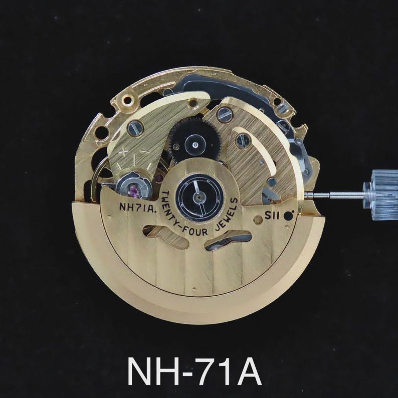 May include: A detailed view of a watch movement featuring gold-toned gears and mechanisms. The text "Twenty-Four Jewels" and "NH71A" are displayed. A transparent, cylindrical part protrudes from the right. The background is black.