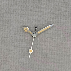 May include: Close-up of watch hands against a grey background. The hands are silver with yellow accents and a black dot. The hour hand has a circular design with yellow fill, and the minute hand is a silver arrow.