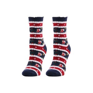 May include: A pair of cozy, patterned socks. The socks feature a navy blue base with red and white stripes, and a repeating pattern of green Christmas trees and gift boxes. The top edge of the socks has a ruffled trim.