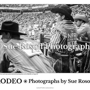 May include: Black and white photograph of three cowboys at a rodeo event. The cowboys wear hats and striped shirts. The image includes the text "NFR LAS VEGAS" and "RODEO Photographs by Sue Rosoff."