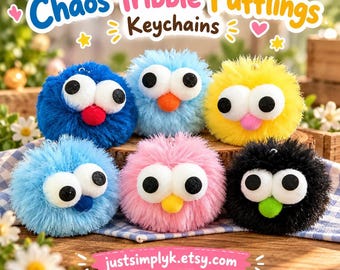 May include: Six fuzzy, round pom-pom keychains labeled Chaos Tribble Pufflings Keychains. Each features two large white eyes with black pupils and a small colored nose. Colors include dark blue, light blue, yellow, pink, and black.