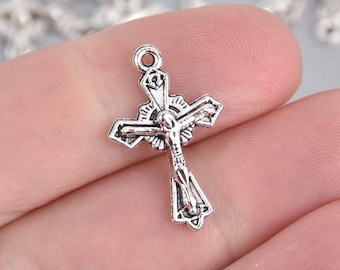 May include: Silver-toned metal crucifix charm with a detailed design. The charm features a figure of Jesus Christ on the cross.