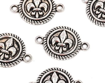 May include: Several antique silver-colored Fleur-de-lis charms. Each charm is round with a rope-like border and two small loops for attachment. The Fleur-de-lis symbol is centered within the circle. These charms are ideal for jewelry making or craft projects.