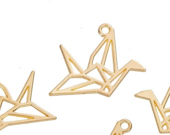 May include: Five gold-colored origami crane charms. Each charm is a stylized representation of a crane, with a loop at the top for attaching to jewelry or other crafts. The charms are made of a shiny, metallic material.