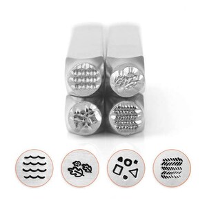 May include: A set of four metal stamps with various textured designs, including waves, leaves, geometric shapes, and a woven pattern. The stamps are displayed with their corresponding impressions, showcasing the detailed patterns. The stamps are made of silver metal.