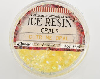 May include: A small clear jar filled with yellow and iridescent glitter. The label reads "Ice Resin Opals Citrine Opal .14oz (4g) Susan Lenart Kazmer Ranger"