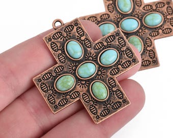 May include: Two copper cross charms with turquoise stones. Each cross has a detailed design and is adorned with oval-shaped turquoise stones.