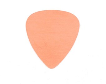 May include: A peach-colored guitar pick.