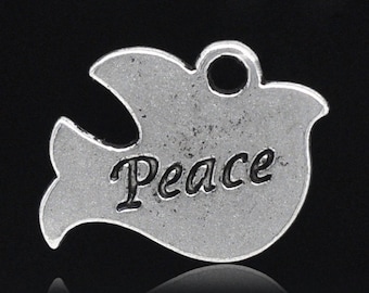 May include: A silver-colored dove charm with the word "Peace" inscribed on its body. The charm has a loop at the top for attaching to a necklace or bracelet. The dove is a symbol of peace and hope.
