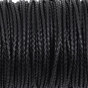 May include: Close-up of a spool of black braided leather cord. The cord is tightly wound and has a textured surface.