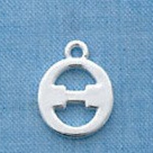 May include: A silver-colored charm with a circular frame and a stylized letter "H" in the center. The charm has a small loop at the top for attachment. The background is a solid light blue.