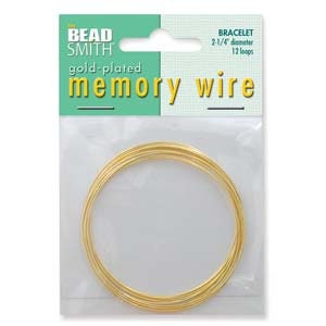 May include: A package of gold-plated memory wire for bracelets. The package is white and green with the text "BEAD SMITH" and "gold-plated memory wire". The wire is 2 1/4 inches in diameter and has 12 loops.