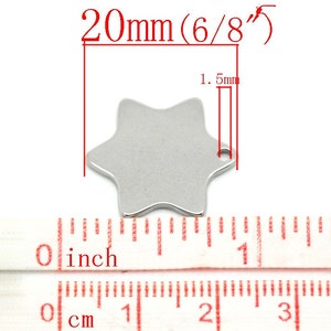 May include: A silver-colored, six-pointed star charm with a small hole for stringing. The charm measures 20mm (6/8") in diameter and 1.5mm thick. A ruler with inch and centimeter markings is shown below the charm.