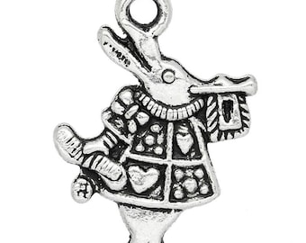 May include: Antique silver charm in the shape of a rabbit dressed in a detailed outfit, holding a scroll. The charm has a loop at the top for attaching to a necklace or bracelet. The text "Antique Silver" is visible.