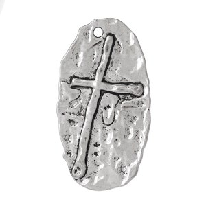 May include: A silver oval charm with a textured surface and a raised cross design.