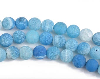 May include: Strand of blue gemstone beads in varying shades, from light to deep blue. The round beads have a cracked, textured appearance, creating a unique visual effect. Ideal for jewelry making or crafting projects.