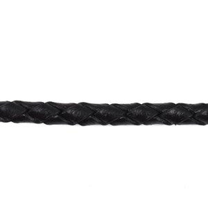 May include: Black braided leather cord. The cord is woven in a diamond pattern.