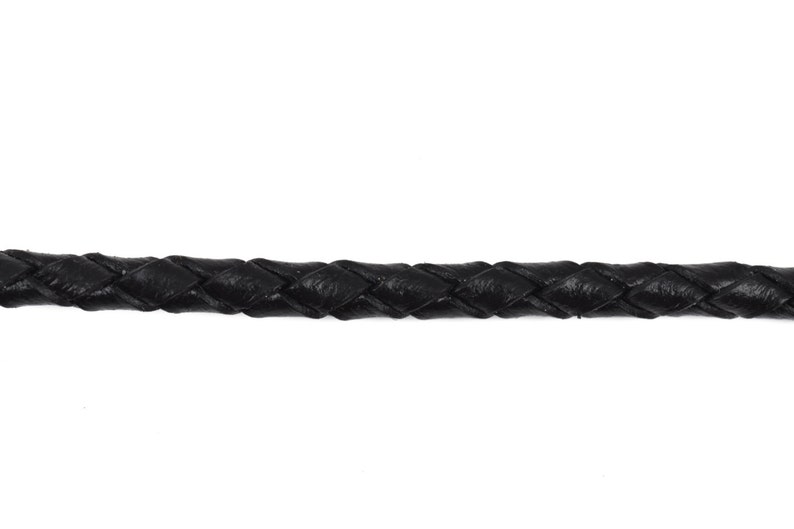 May include: Black braided leather cord. The cord is woven in a diamond pattern.