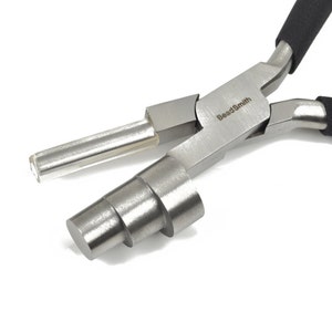 May include: A pair of silver-colored BeadSmith pliers with black handles. The pliers have a stepped mandrel and a clear plastic tube on one side. The brand name "BeadSmith" is printed on the pliers.