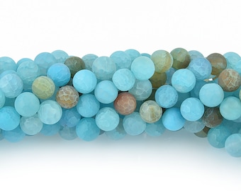 May include: A strand of round, faceted beads in shades of light blue, turquoise, and brown. The beads have a textured surface and are strung together, suitable for jewelry making or crafting projects. The beads are approximately 8mm in diameter.