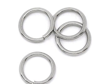May include: Close-up of several silver-colored jump rings. The rings are circular with a small gap, allowing them to be opened and closed. The rings are made of a shiny, metallic material, and are arranged on a white background.