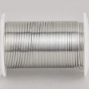 May include: A spool of shiny, silver-colored solder wire. The wire is tightly wound around a white plastic spool. The solder wire appears to be made of a metal alloy, reflecting light and creating a bright, metallic appearance.