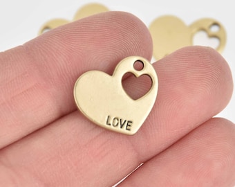May include: Gold-toned metal heart charm with a cut-out heart and the word "LOVE" inscribed on the front.