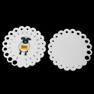 May include: Two white plastic knitting gauge tools. One features a black and white sheep graphic with the word "Knit" on a yellow tag. The gauge has numbered holes for measuring needle sizes. The other gauge is blank.