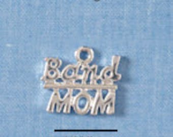 May include: A silver-colored charm with the words "Band MOM" in a stylized font. The charm has a small loop at the top for attaching to a chain or bracelet. A 1/2" line is below the charm.