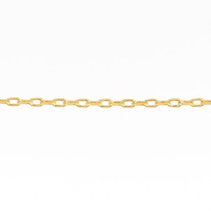 May include: A close-up of a gold-colored chain against a white background. The chain is composed of small, oval-shaped links. The chain is a jewelry item.