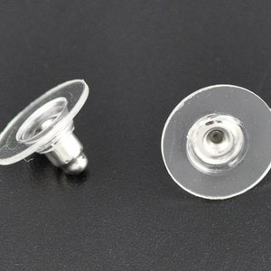 May include: Two clear plastic earring backs with a silver metal post and a small silver ball at the end.