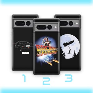 May include: Three black smartphone cases featuring Back to the Future designs. The first shows a white DMC car outline, the second displays the movie logo and character, and the third depicts a silhouette of the car against a large white moon.