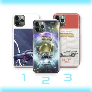 May include: Three phone cases with different designs. One case features a DeLorean car with a lightning bolt, another has the "Back to the Future II" movie poster, and the third has a DeLorean car illustration with the text "88 MPH 7.3.1985".