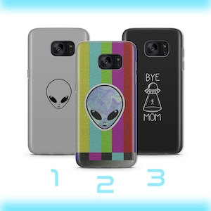 May include: Three phone cases with alien designs. One is gray with a black alien head, another has a colorful striped pattern with an alien head, and the third is black with a UFO and the text "BYE MOM".