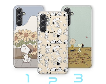 May include: Three phone cases with Snoopy and Charlie Brown designs. One case shows Snoopy with sunflowers, another has a pattern of Snoopy characters, and the third depicts Charlie Brown and Snoopy in a fall scene. The cases are numbered 1, 2, and 3.